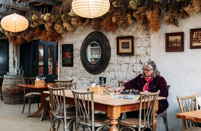 Customer sitting at a table at Orchard Garden Cafe.