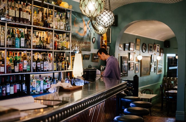 Bartender behind bar.