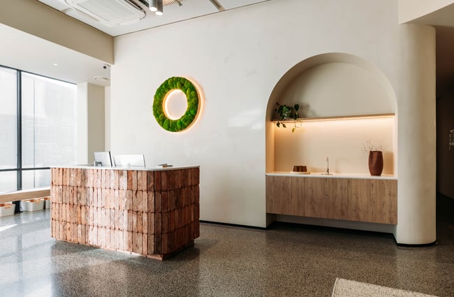 Front desk in the lobby area, with O-Studio signage behind the desk..
