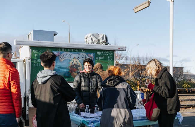 Customers talking to a stall owner.