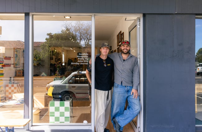 Owners of Outdoors Society standing in entranceway of shop in Auckland
