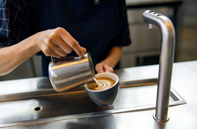Barista pouring a coffee at Ozone Coffee.