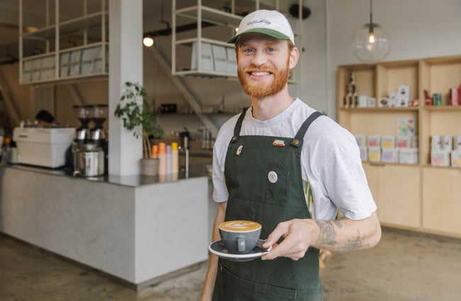 Barista holding coffee at Ozone Coffee Walker Street.