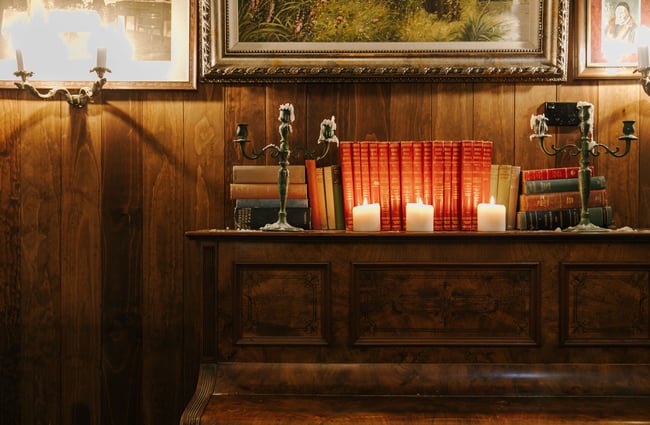 Piano with candlestick on the top with old fashioned books at Paddy McNaughton's, Christchurch.