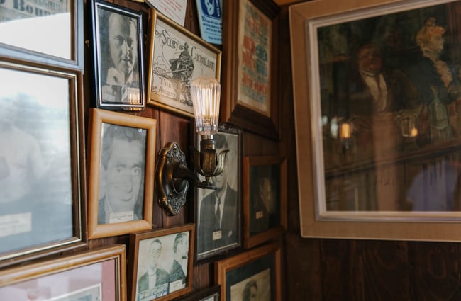 Pictures and art work framed on the wall at Paddy McNaughton's, Christchurch.