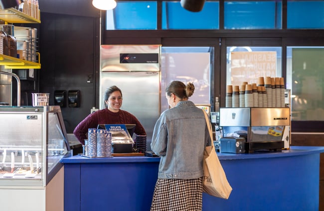Customer ordering at the gelato counter at Paleta Gelateria.