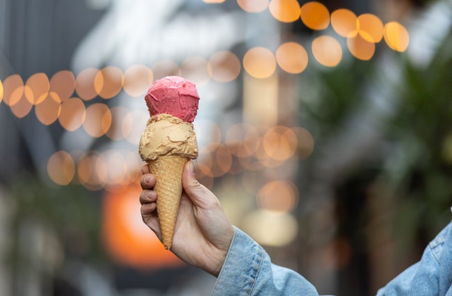 Customer holding a gelato cone from Paleta Gelateria.