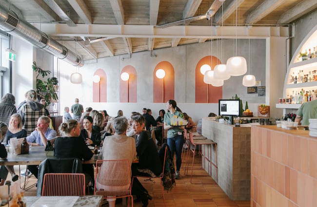 The interior of the Paloma Mexican restaurant filled with people dinning at the tables.
