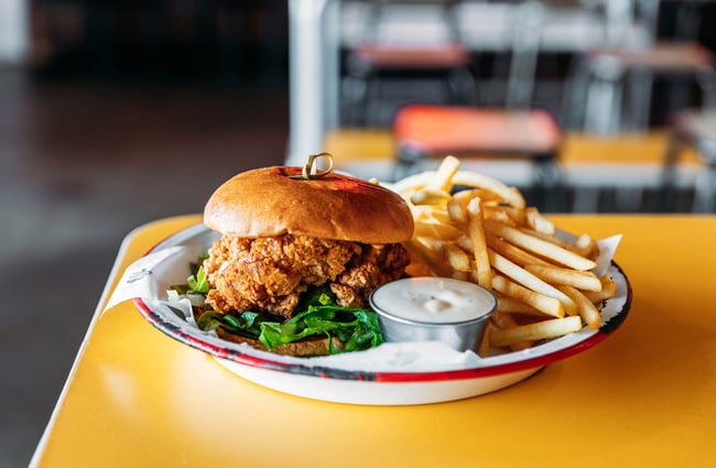Chicken burger and fries on plate at Parrotdog in Wellington