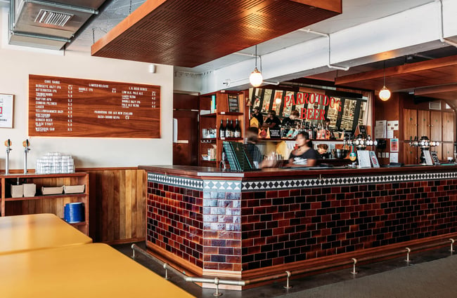 Main bar area at Parrotdog Brewery in Lyall Bay with retro signage and antique mirror