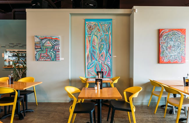 Colourful seats around tables inside Passo restaurant.