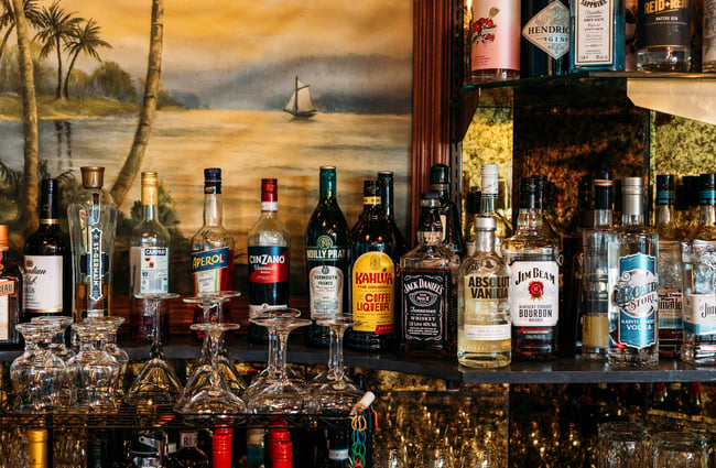 Bottles of liquor lined up on shelves.