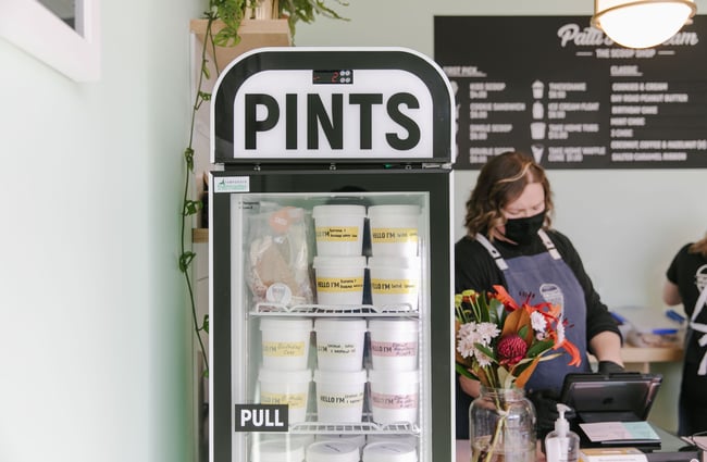 Pints of ice cream for sale in fridge at Patti's and Cream.