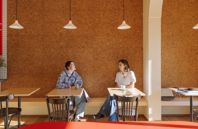 Customers sitting at tables talking to each other at Peaches.