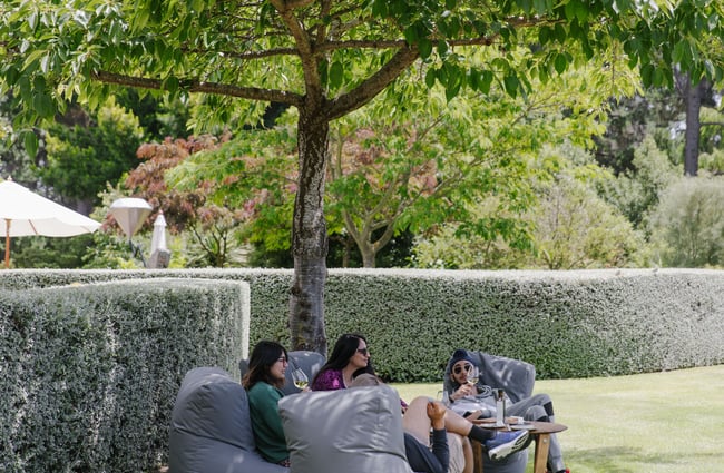 People on beanbags enjoying wine at Pegasus Bay.