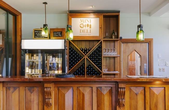 Wines on display behind counter area at Pegasus Bay.