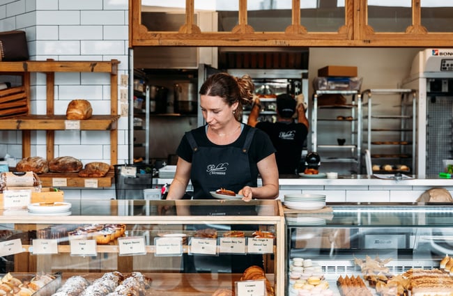 Female staff member behind the counter at Pembroke Pâtisserie, Wānaka.