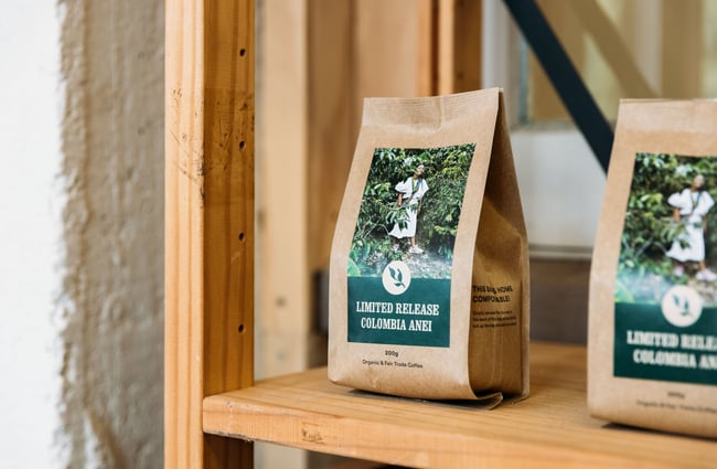 A close up of a bag of coffee beans on a shelf.