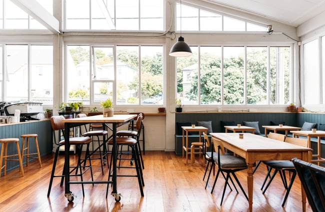 Tables and chairs inside Peoples Coffee Roastery in Wellington.