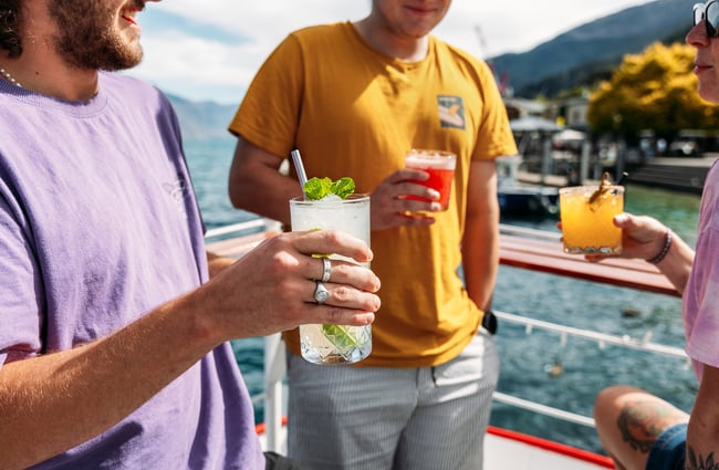 Three people holding cocktails.