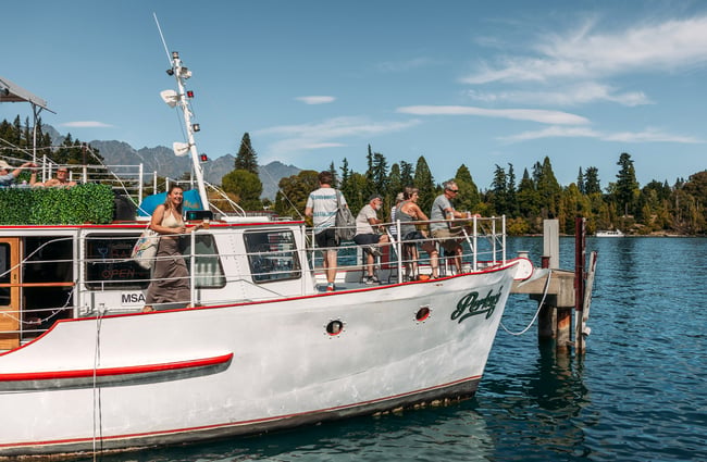 People on a white boat on a sunny day.