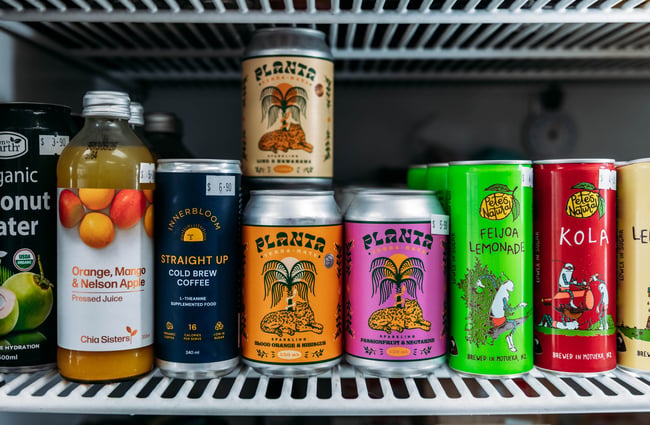 A selection of canned drinks in the fridge at Petal Bee Grocers.