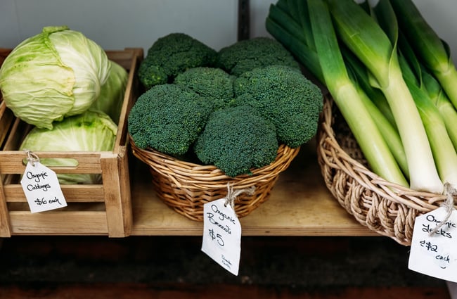 Cabbages, broccolis and leeks in baskets at Petal Bee Grocers.