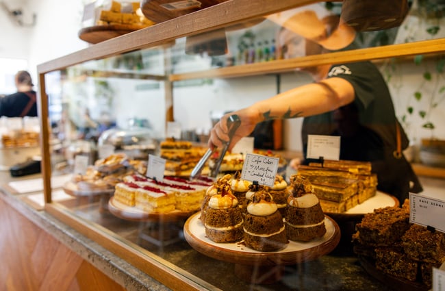 Cafe staff taking something out of the food cabinet at Pete & Mary's Eatery.