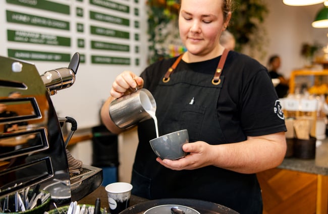 Barista pouring a coffee at Pete & Mary's Eatery.