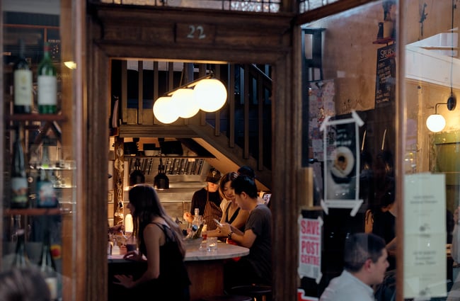 Looking through the doorway of Pici in Auckland where people are dining at the bar