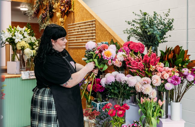 A woman sorting flowers.