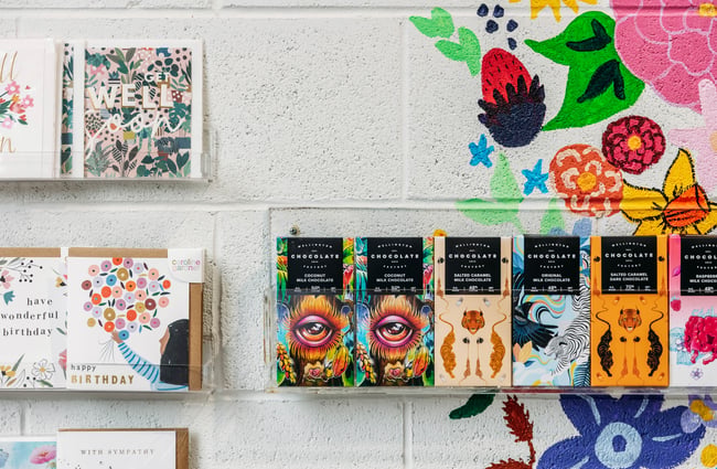 Cards and chocolate on display on a wall.