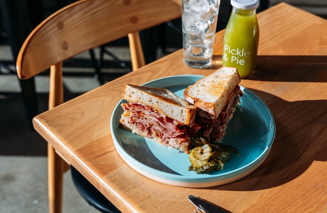 Sandwich and a juice on the table at Pickle and Pie.
