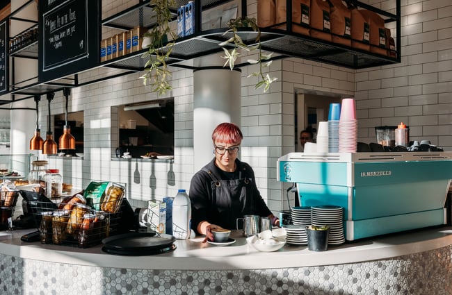Barista behind the coffee machine at Pickle and Pie.