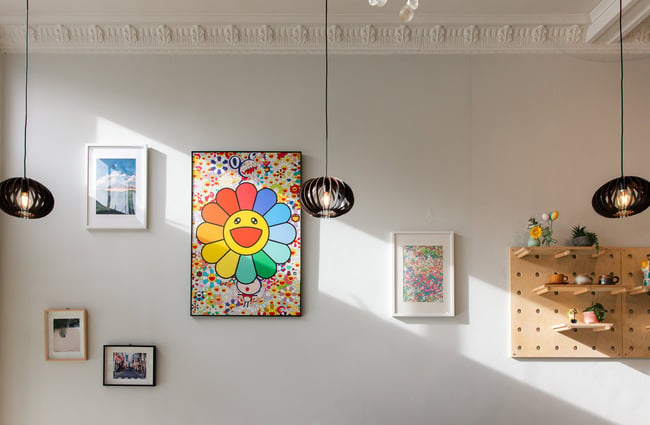 A close up of works of art on a wall.