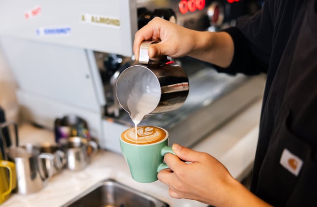 Milk being poured into a cup.