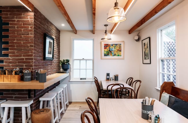 Interior brick decor and tables and chairs at Pinot Junction.