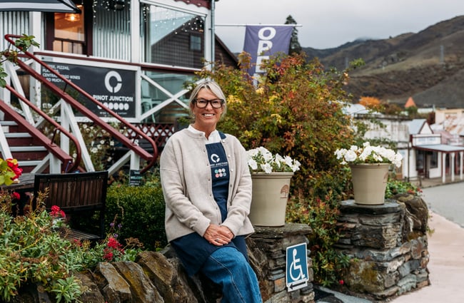 Owner Kate sitting outside Pinot Junction.