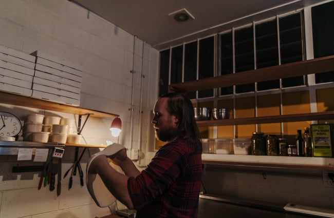 Man spinning pizza dough.