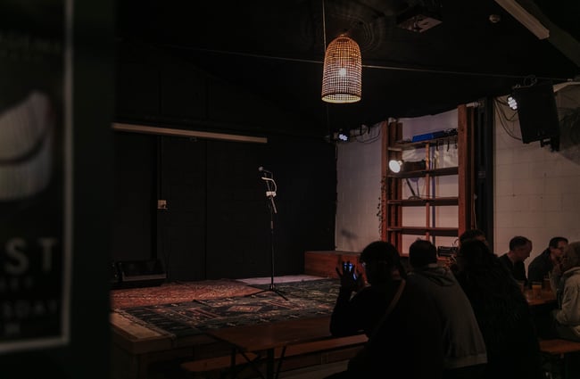 Microphone stand on a rug.