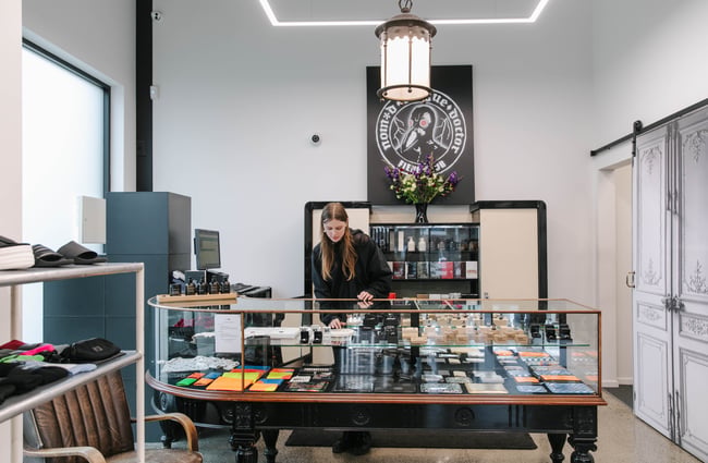 A staff member behind the counter at PLUME.