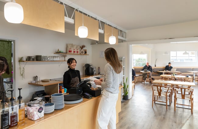 Barista serving a customer at the counter at Poca Poca.