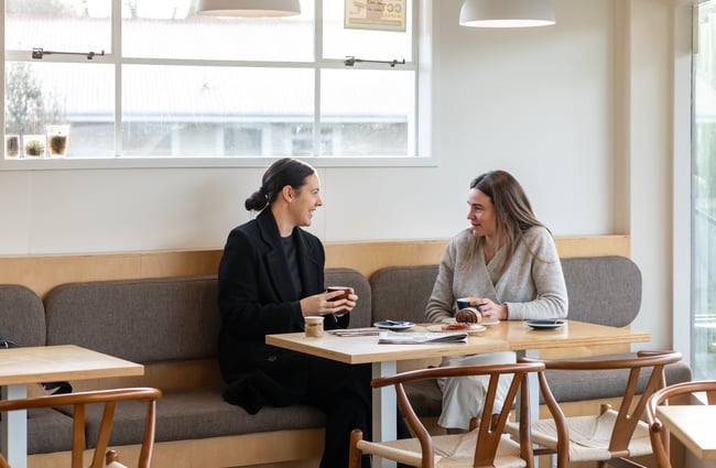 Customers talking to each other at a table at Poca Poca.