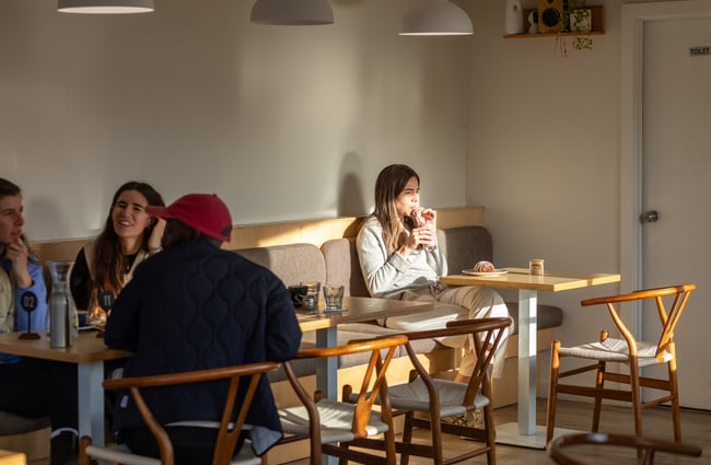 Customers sitting at tables in the dining area of Poca Poca.