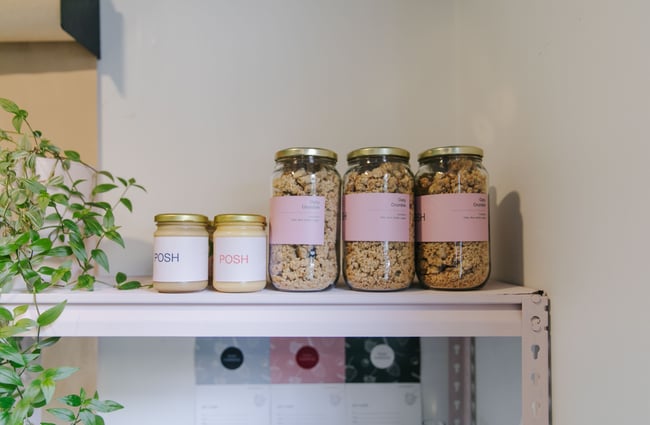 Posh Porridge granola for sale on shelves.