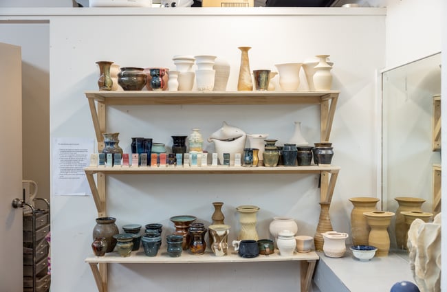 Products are on a shelf at Pottery Capital.
