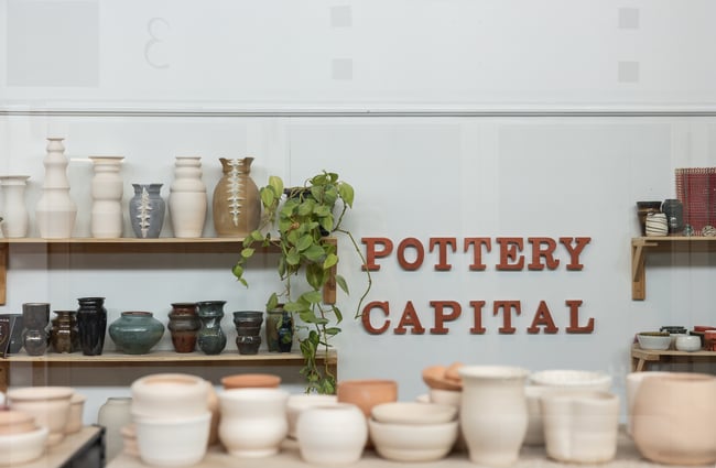 Shelving lineup of ceramics at Pottery Capital.