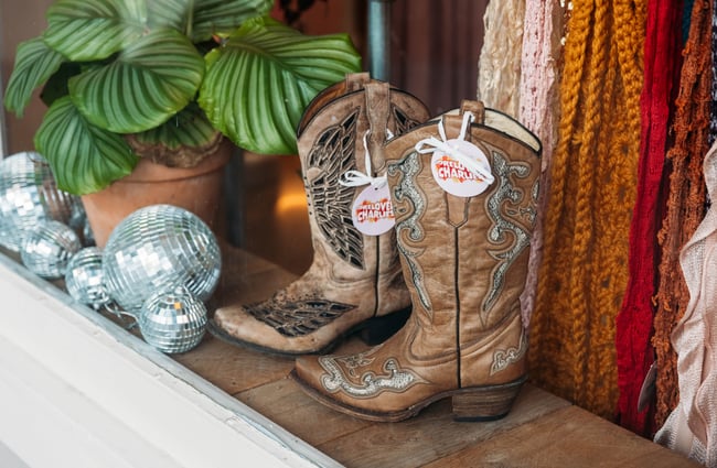 Cowboy boots and disco balls on display at Preloved Charlies.