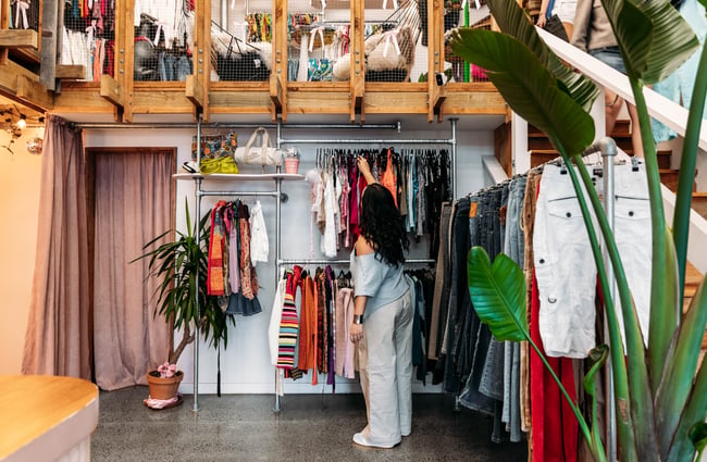 Customer browsing the clothing racks at Preloved Charlies.