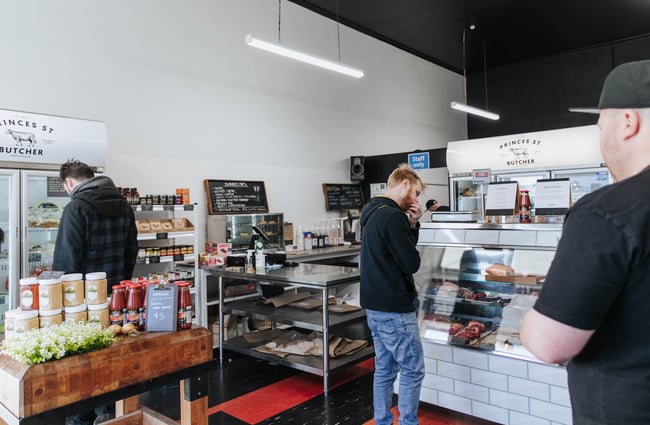 Customers browsing the cabinet displays in the butchery.